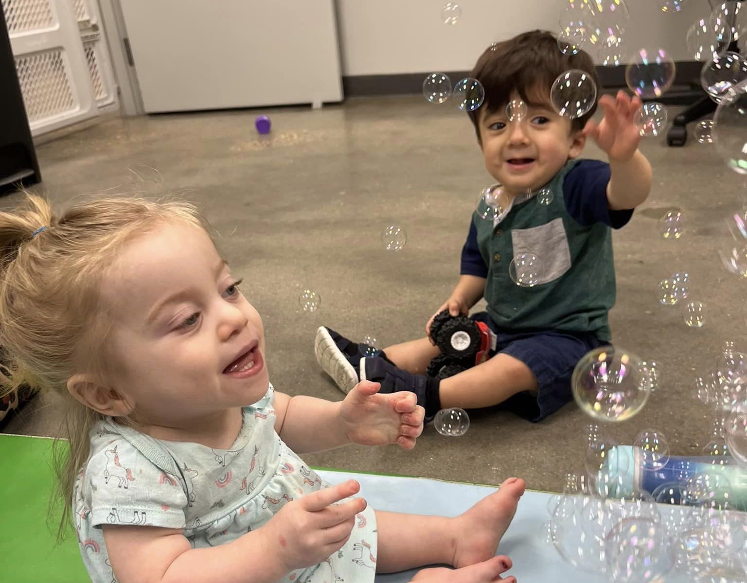 Playing together with bubbles at a child care for a disabled child